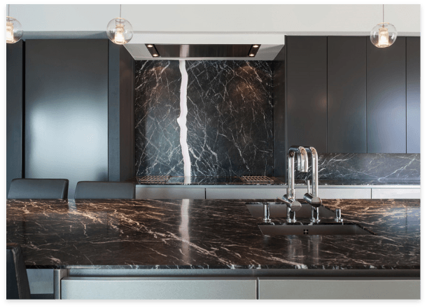 Modern kitchen with sleek black marble countertops and matching cabinets.