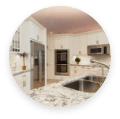 Bright kitchen with white cabinetry, sleek stainless steel appliances, and beautiful quartzite countertops.