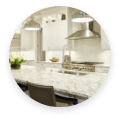 Modern kitchen featuring white cabinets and quartz countertops.