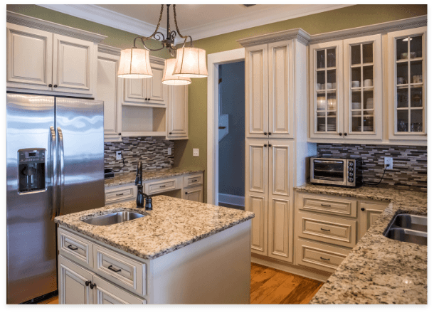 Modern kitchen with granite countertops, stainless steel appliances, and marble accents.