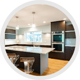 Modern kitchen with spacious island, stainless steel appliances, and sleek countertops with lights