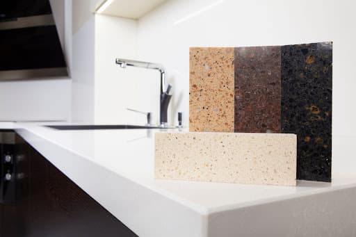 A kitchen counter with multicolored granite tiles.