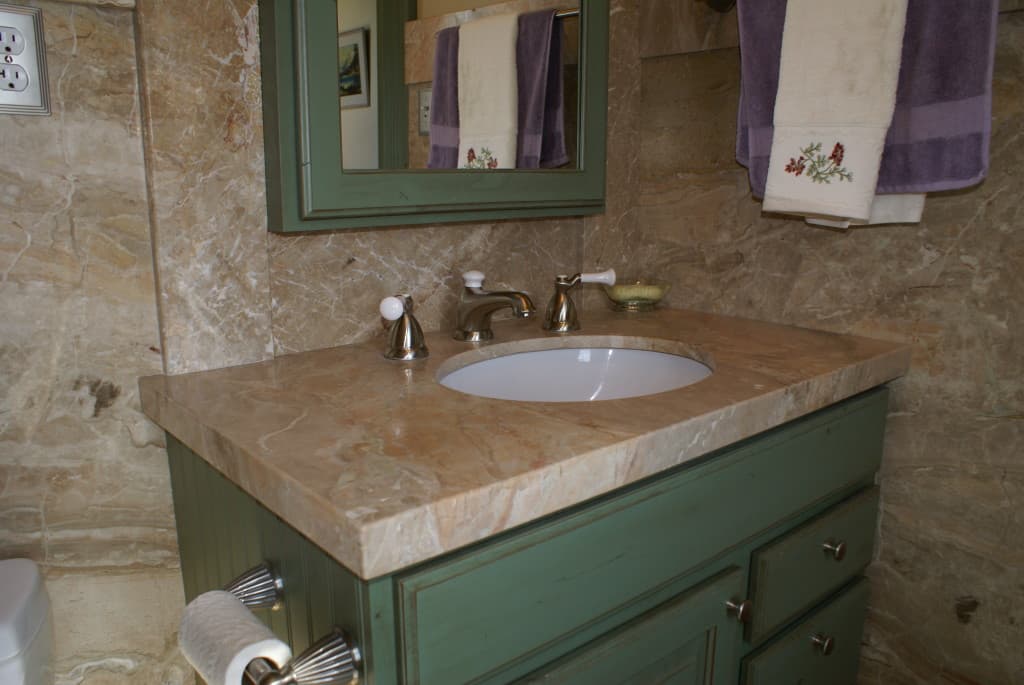 A stylish bathroom showcasing a sleek sink and a mirror, enhancing the room's contemporary design.