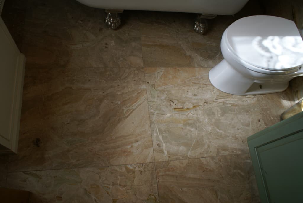 Interior of a bathroom featuring a toilet and a sink.