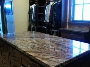 Modern kitchen with granite counter top and closet.