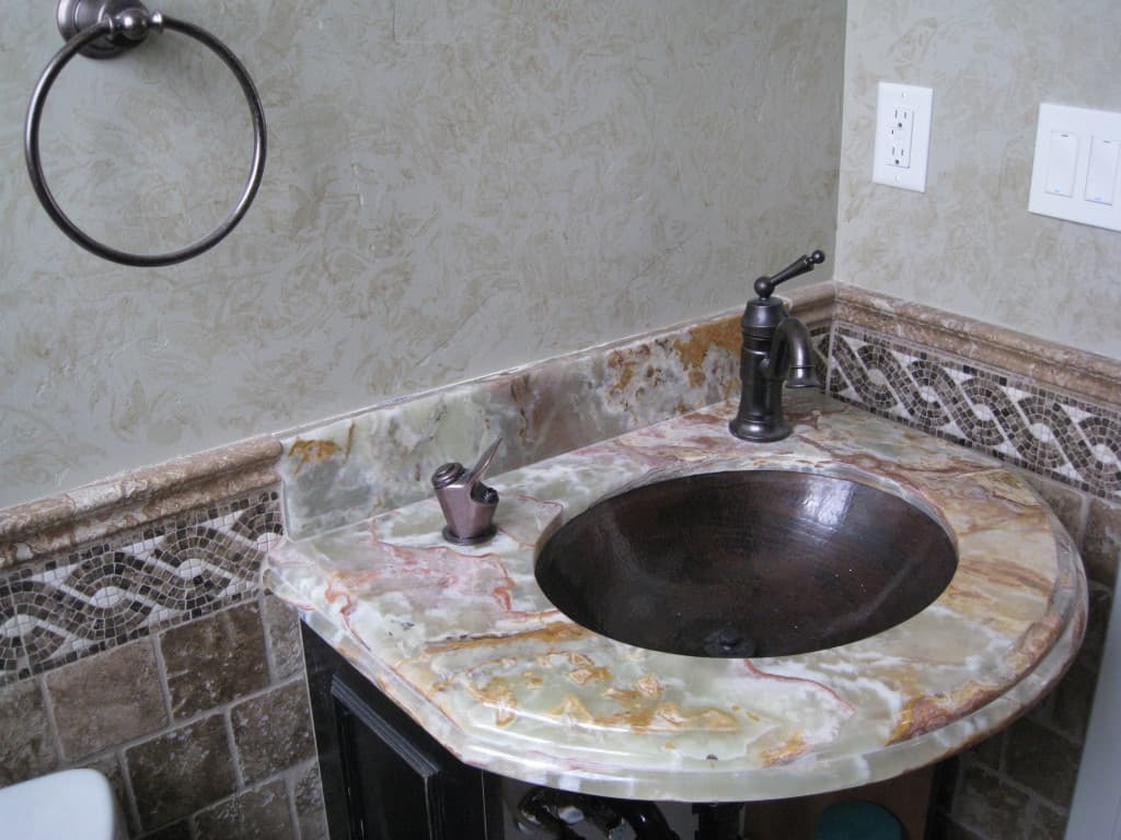 A stylish bathroom sink with a polished marble countertop, exemplifying sophistication and contemporary design.
