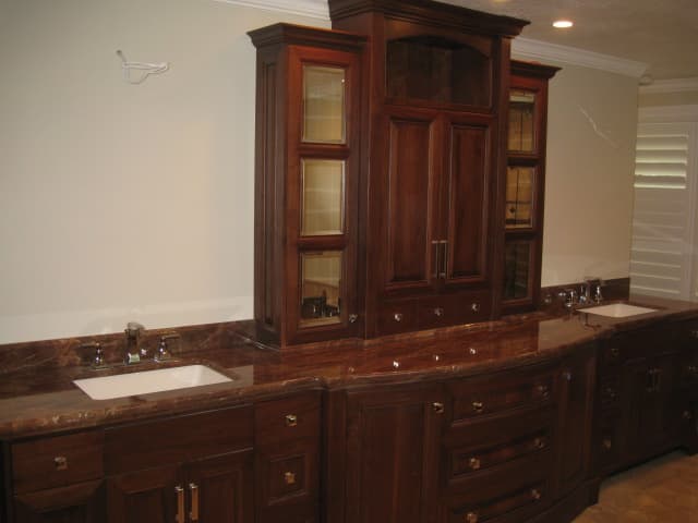 A modern bathroom featuring two sinks and a stylish cabinet, showcasing a clean and organized space.