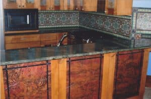 Kitchen with marble counter top and wooden cabinets in a modern style.