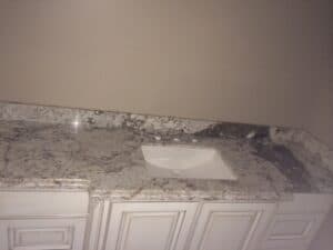Bathroom with granite counter tops and sink.