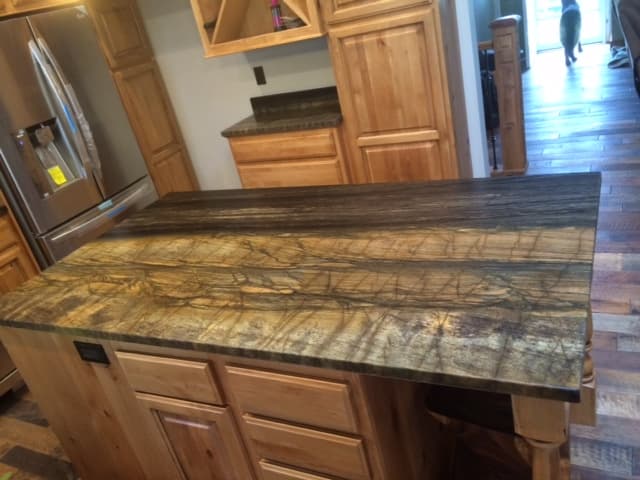 A small kitchen sink surrounded by wooden cabinets.