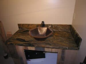 Brown marble counter top with a sink.