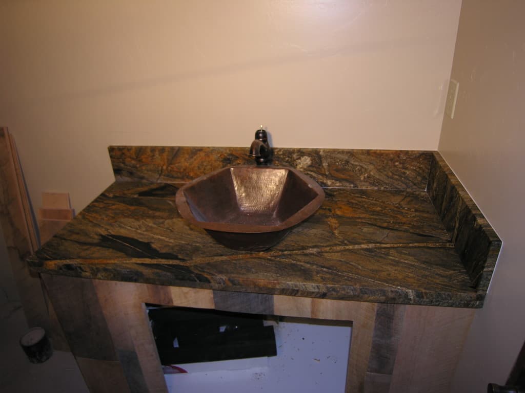 Brown marble counter top with a sink.