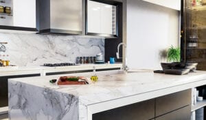 A modern kitchen featuring a sleek marble countertop and a stylish sink, showcasing Intermountain Stone and Marble craftsmanship.